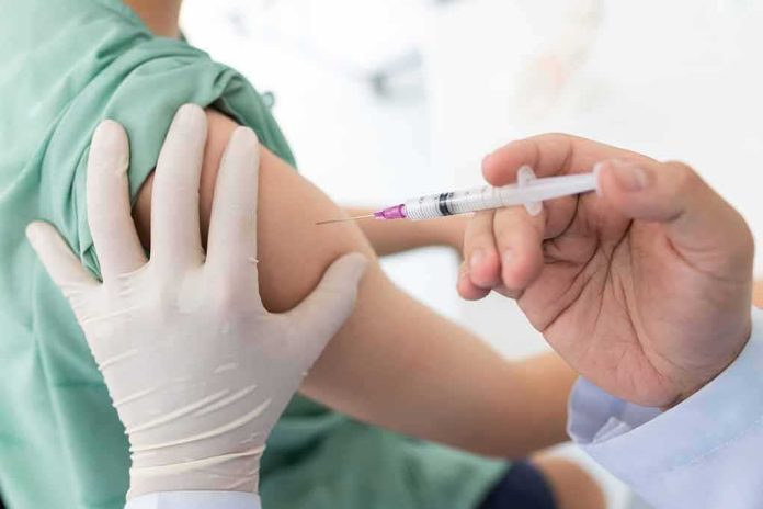 shutterstock_1740628409-1 Healthcare worker giving an intramuscular injection in upper arm