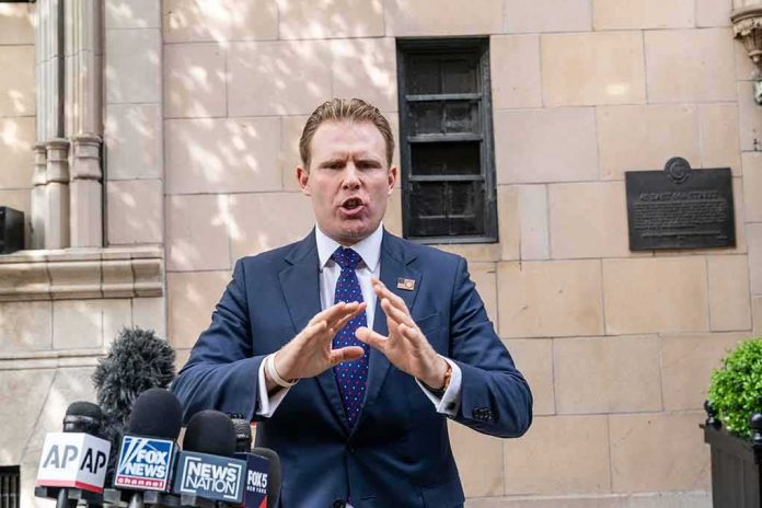shutterstock_1965169666 Man in suit speaking at outdoor press conference