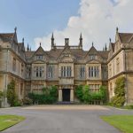 Historic mansion with ornate stone facade and gabled roofs
