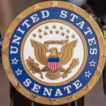 United States Senate seal at a podium
