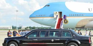 Iran Threat Forces Trump Onto Older Plane Presidential limousine beside a large blue-and-white jet on a runway