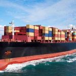 Container ship carrying stacked cargo at sea