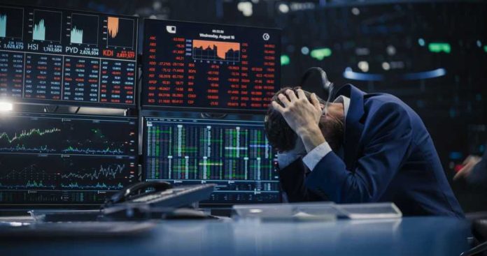 2388692919-1 Trader stressed out by multiple declining stock charts.