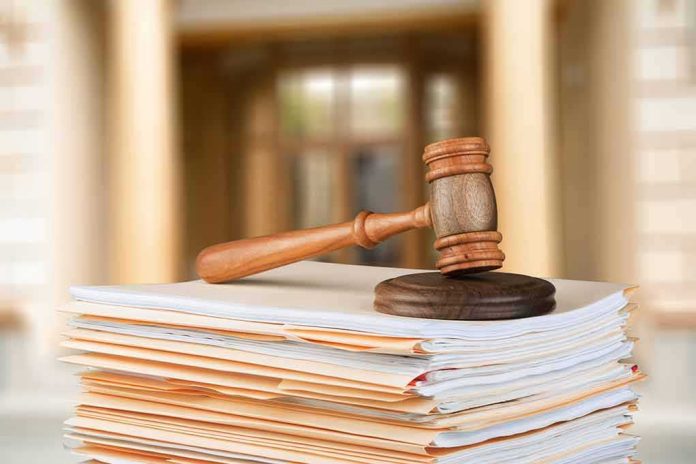 shutterstock_1025580877-1 judge's gavel resting on a stack of case files