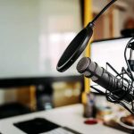 War Room Becomes Populist Media Hub Under Fire Podcast microphone with pop filter on desk