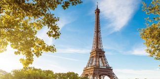 Women Told to “Step Aside” For Hindus at Eiffel Tower Eiffel Tower in Paris with boats on the river and green trees