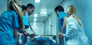 Army Reviews 2,544 Post-Vaccine Death Reports Medical team rushing patient on a gurney through hospital corridor