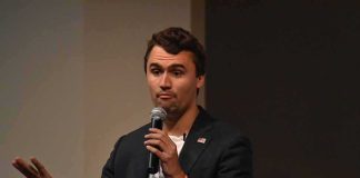 Rooftop Shot Sparks: Utah Campus Faces New Scrutiny man speaking into a microphone during a talk