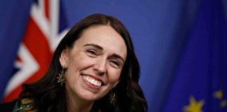 Hollywood Complicity: Celebrities and Politics Collide smiling woman at a podium with flags in the background