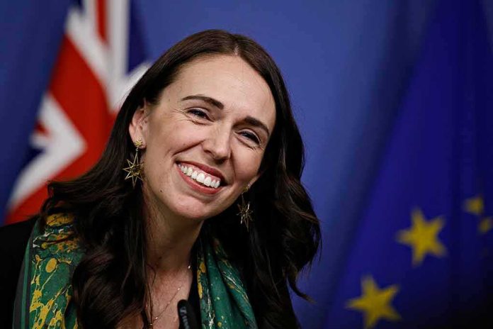 shutterstock_1294621510 smiling woman at a podium with flags in the background