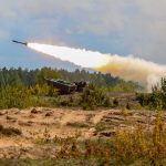 Border War Boils: Hezbollah Attacks Israeli Retaliation rocket artillery launcher firing in a sandy field