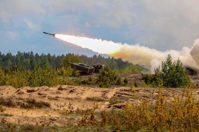 shutterstock_1302196150 rocket artillery launcher firing in a sandy field