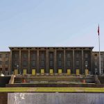 Government building with symmetrical facade and flagpoles