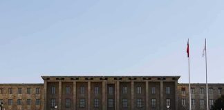 Government building with symmetrical facade and flagpoles