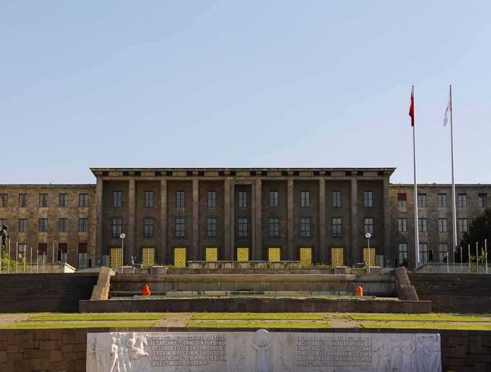 shutterstock_143562406 Government building with symmetrical facade and flagpoles