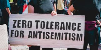 Protester holding a large sign at a rally