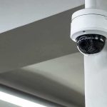 Dome security camera mounted on a ceiling corner