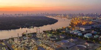 Trump Says U.S. Could Keep Iran’s Oil Industrial oil refinery complex beside a river at dusk