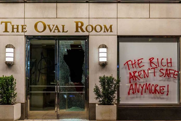 shutterstock_1796219896 vandalized storefront with broken glass door and red graffiti on window