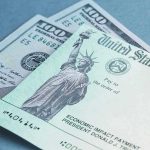 U.S. Treasury check and hundred-dollar bills