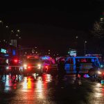 Public Safety: Deadly Montreal Gunfire Sparks Lockdown Nighttime police scene with flashing lights on a wet city street