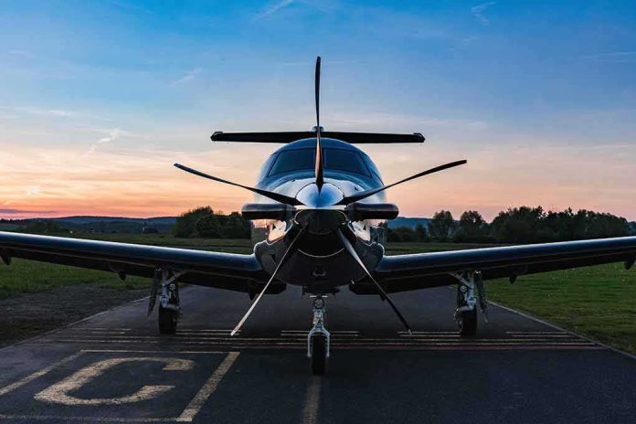 Single-engine propeller airplane on runway at sunset