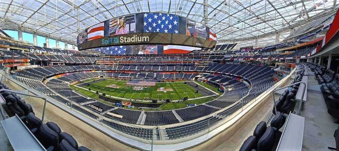 shutterstock_2135248363-1 Football stadium interior with large video board and empty seating