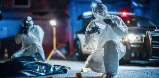 forensic investigators at nighttime crime scene