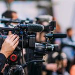 Adam Sandler Was the Surprise Star Video cameras on tripods at a media event