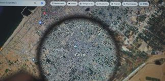 Magnifying glass highlighting Gaza on a digital map