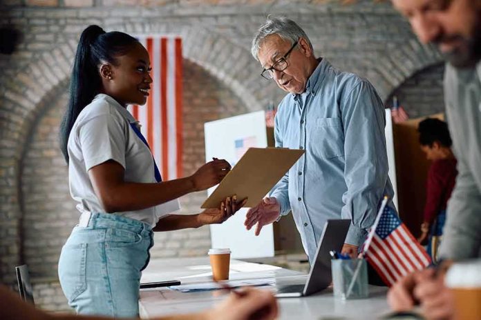 Voter signs a form at a polling station desk