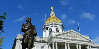 Bronze statue before a domed capitol building