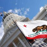 Billionaire Tax Bombshell Hits California California state flag in front of a white domed capitol building
