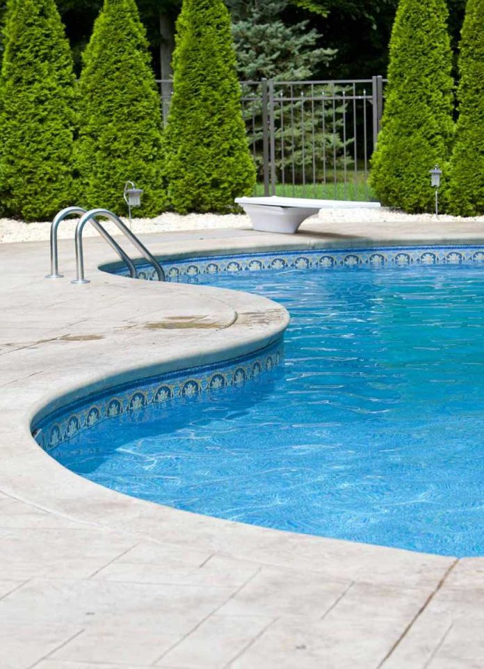 shutterstock_81145300 Outdoor swimming pool with curved edge and diving board