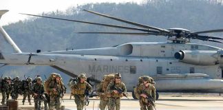 U.S. Troops Complete Iraq Withdrawal Soldiers disembark and walk past a large military helicopter