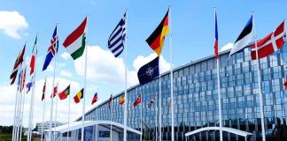 NATO Plans Long-Term Support for Ukraine Row of national flags outside a modern glass building