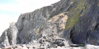 Scientists Push Animal Origins Back 200 Million Years rocky coastal cliff with large boulders at its base