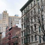 Street view of urban apartment buildings with fire escapes