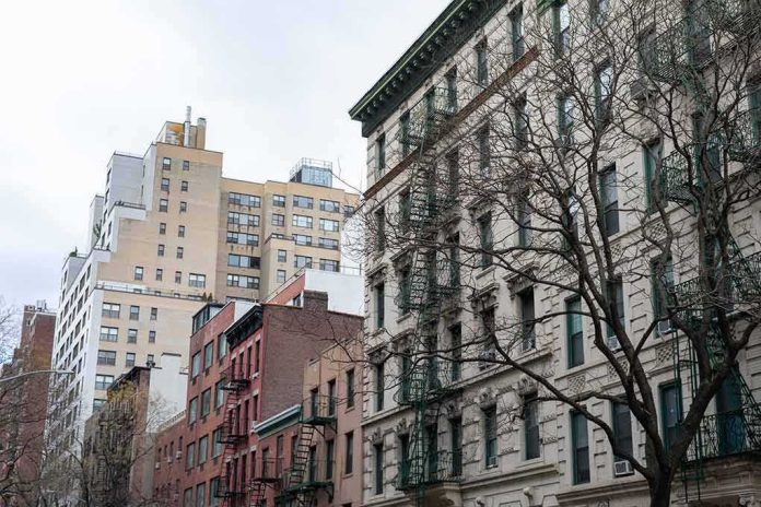 shutterstock_1649879845 Street view of urban apartment buildings with fire escapes