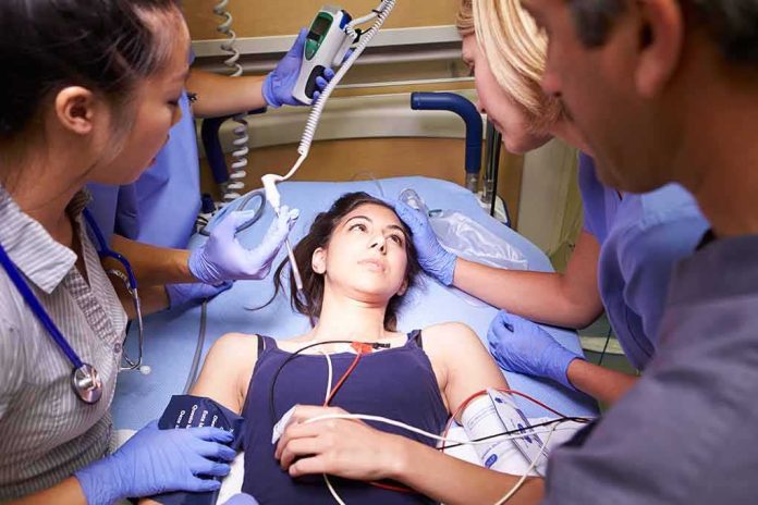 shutterstock_168768599-1 Patient on hospital gurney surrounded by medical staff