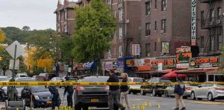 Two Women Killed as Suspect Dies After Bus Standoff Police investigate a taped-off urban street crime scene