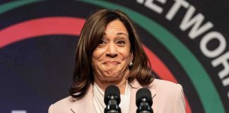 Politician Explains Her Much-Mocked Laugh woman at podium with two microphones