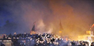 France Protests Turn Violent Riot police gather amid smoke at night