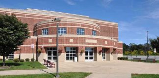 Campus Assault Allegations Under Investigation Exterior view of a modern brick building with a landscaped area and pathway