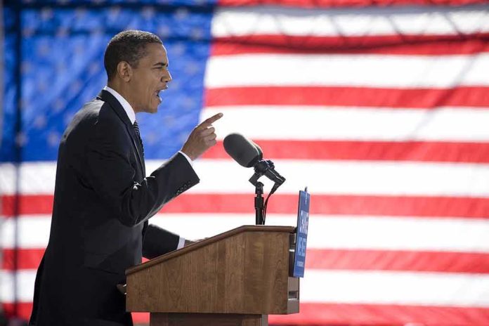 shutterstock_97488068 Speaker at podium with microphones in front of US flag